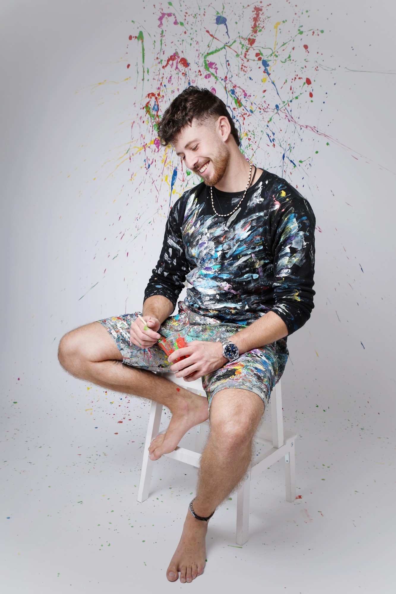 Albert Levi, smiling in his paint-covered clothes